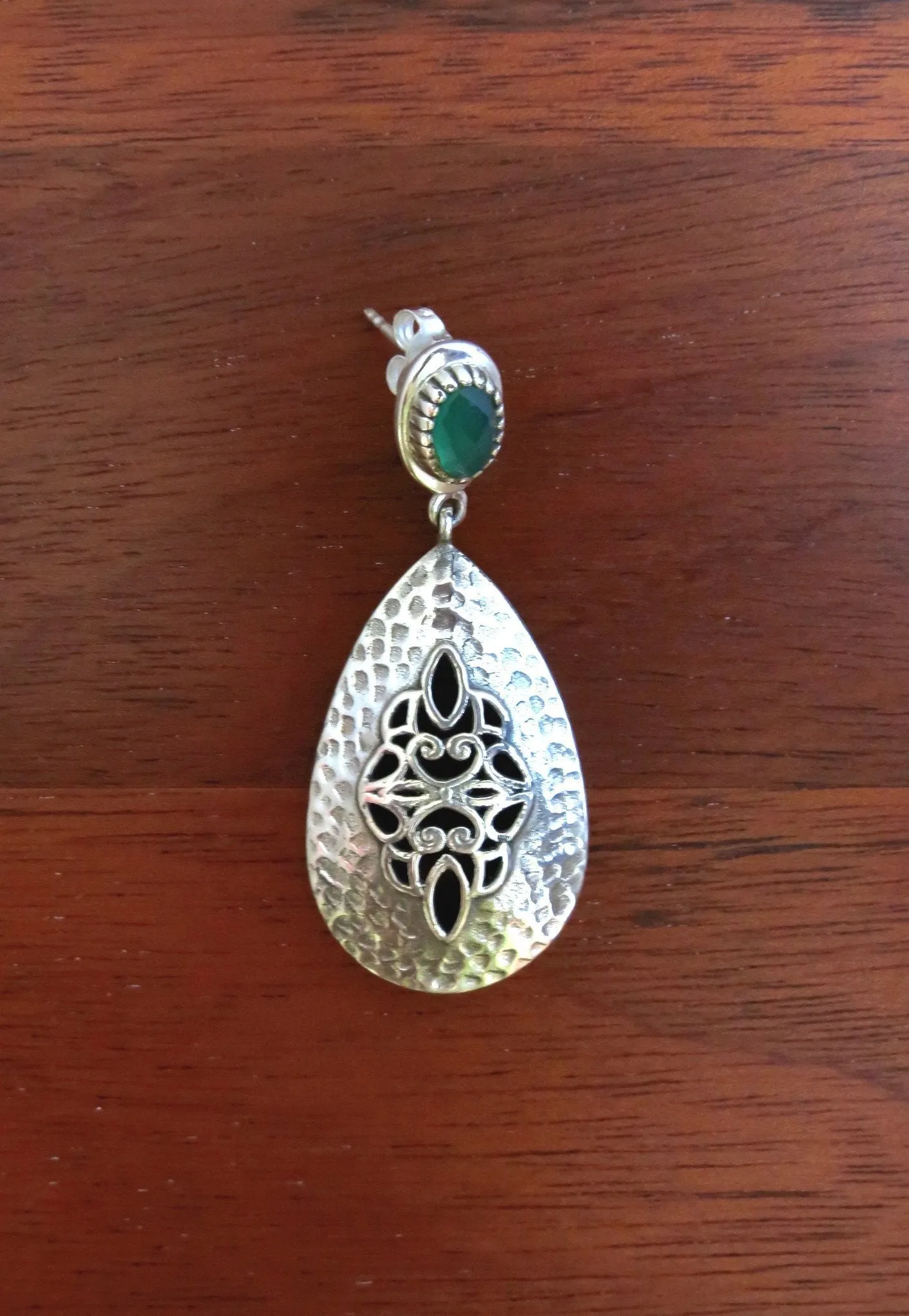Exquisite, jali work and hammer finish earrings accented with green stone